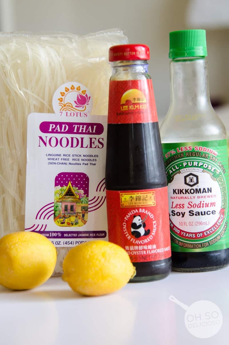 Pansit ingredients: pad thai noodles, soy sauces, and lemons