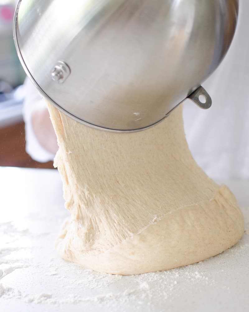 roll dough being poured out on floured surface