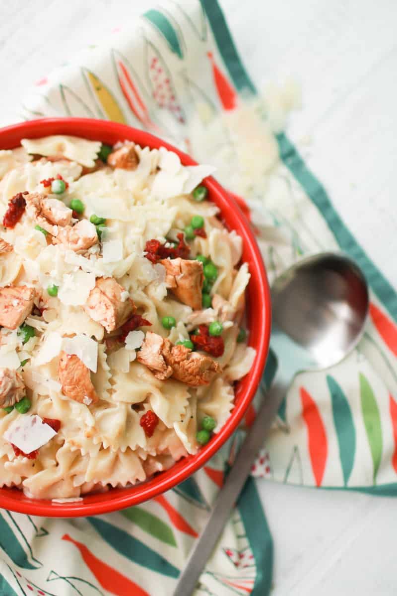 Bacon Chicken Pasta in bowl over fish patterned cloth 