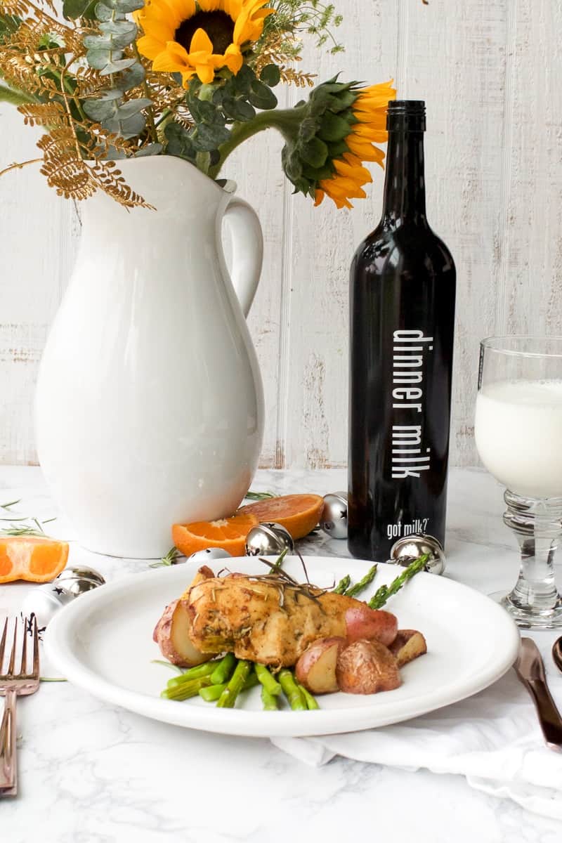 Rosemary Chicken and Potatoes served over asparagus with vase of sunflowers
