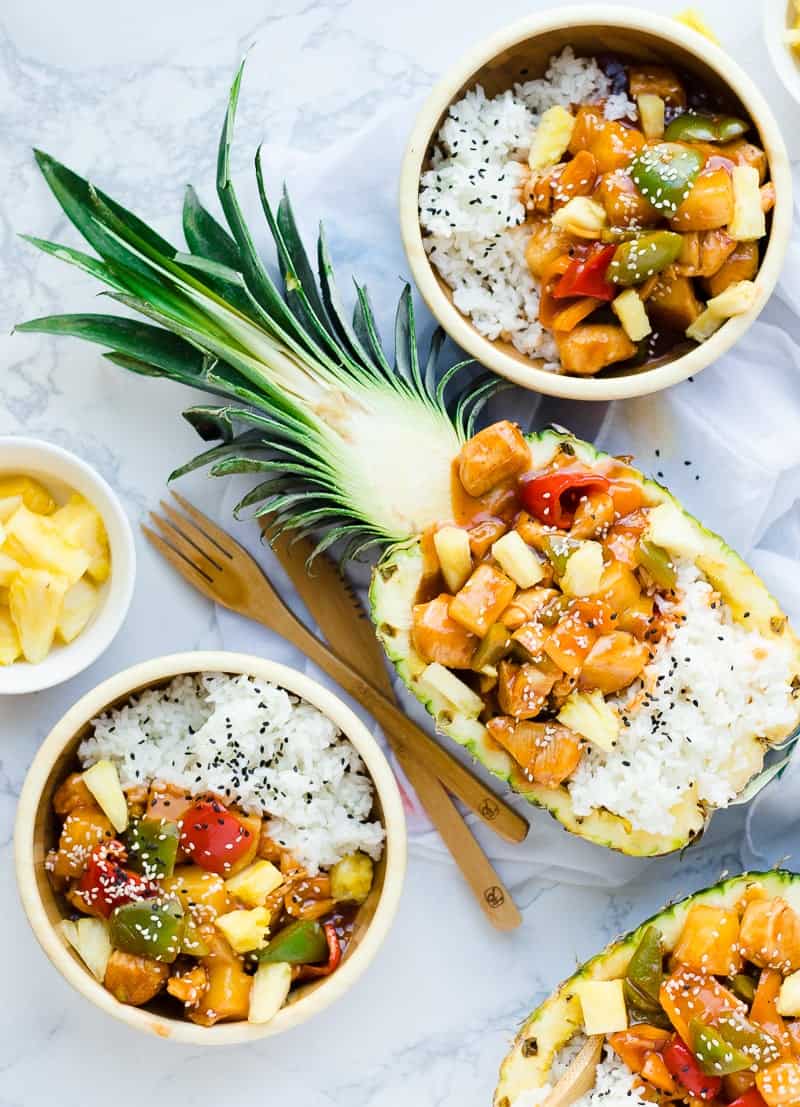 Sweet n Sour Chicken with rice served in bowl and in halved pineapple