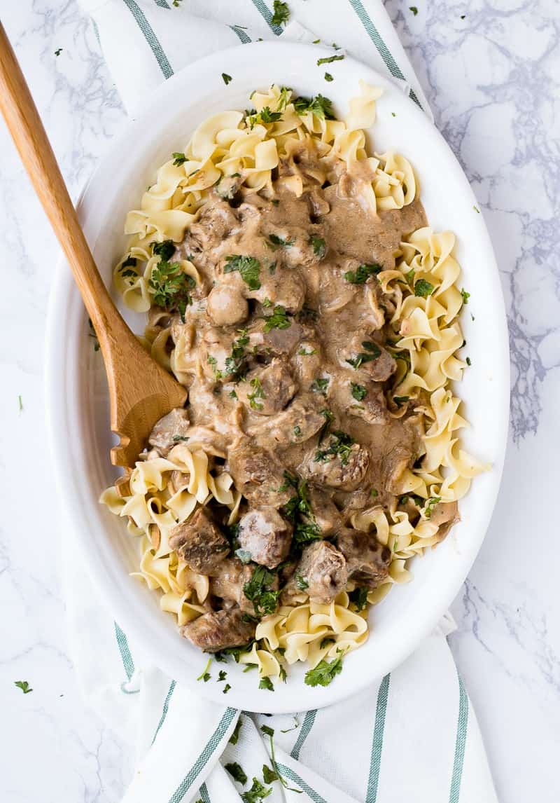 Beef Stroganoff Recipe in white bowl with wooden spoon