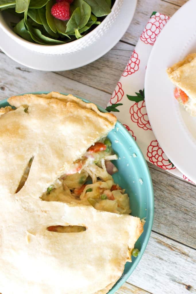 Chicken Pot Pie that has been cut into, with salad to the side
