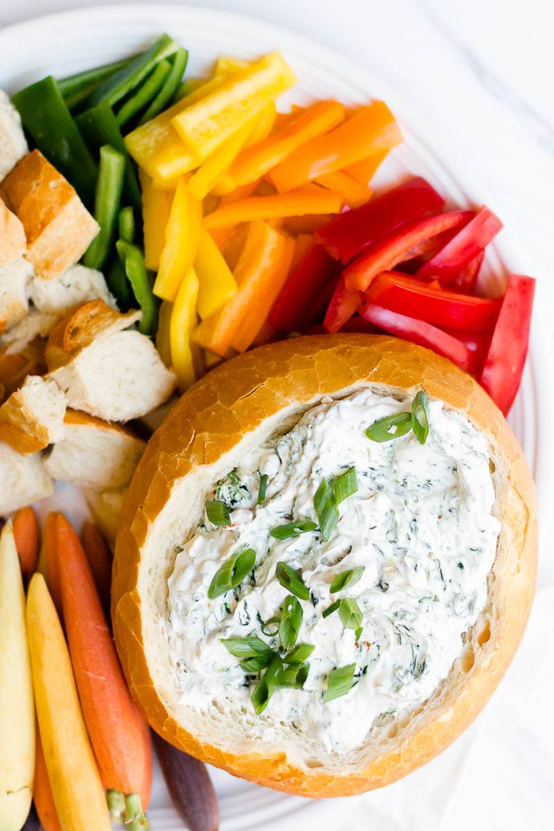 A close up of Easy Spinach Dip in a bread bowl