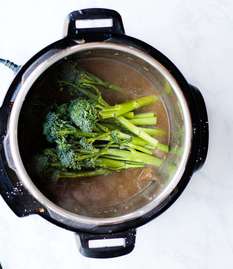 beef and broccoli cooking in an instant pot