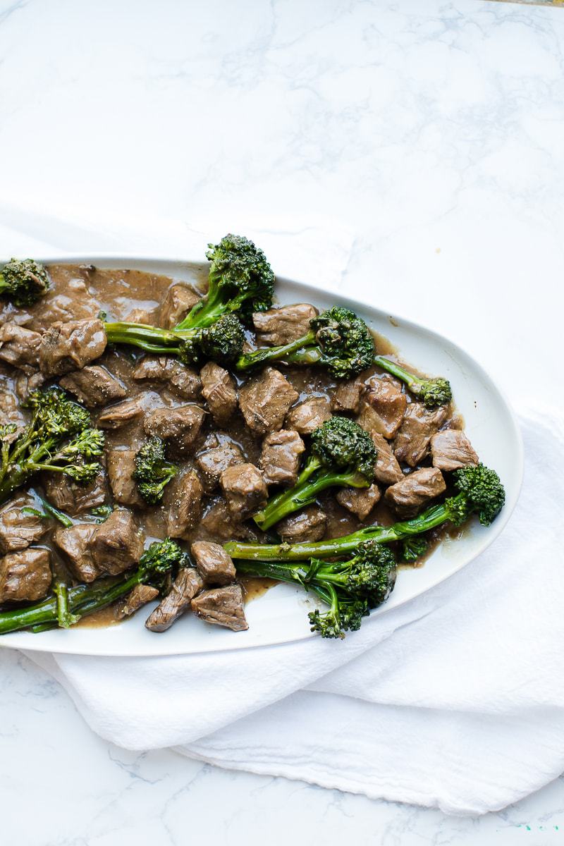 beef and broccoli on a white serving platter