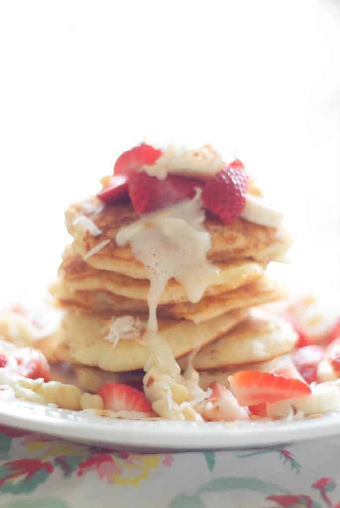 A stack of Tropical Pancakes with chopped strawberries