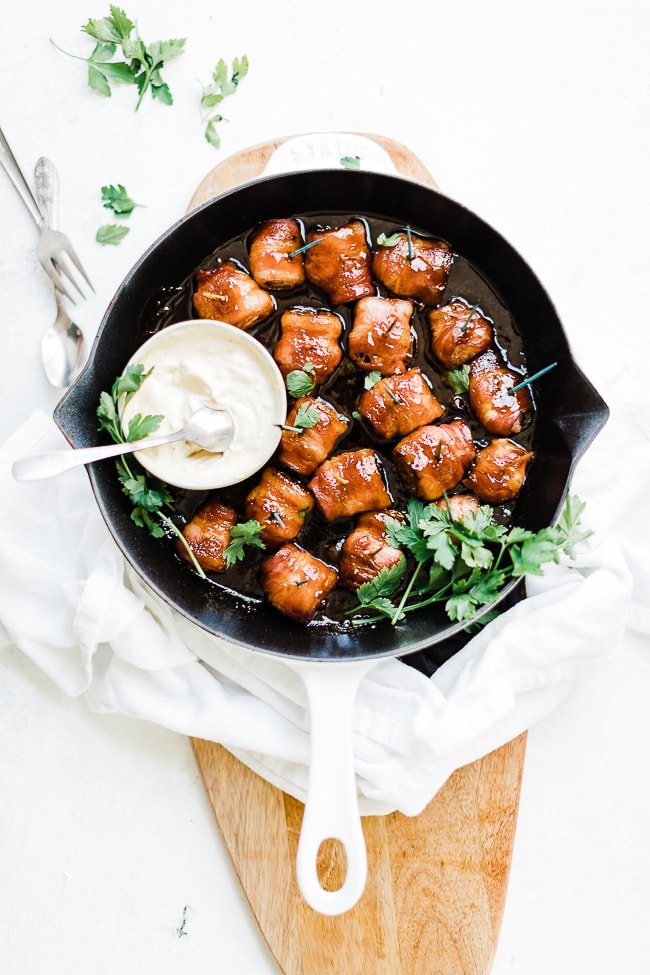 Bacon wrapped water chestnuts in a cast iron skillet.