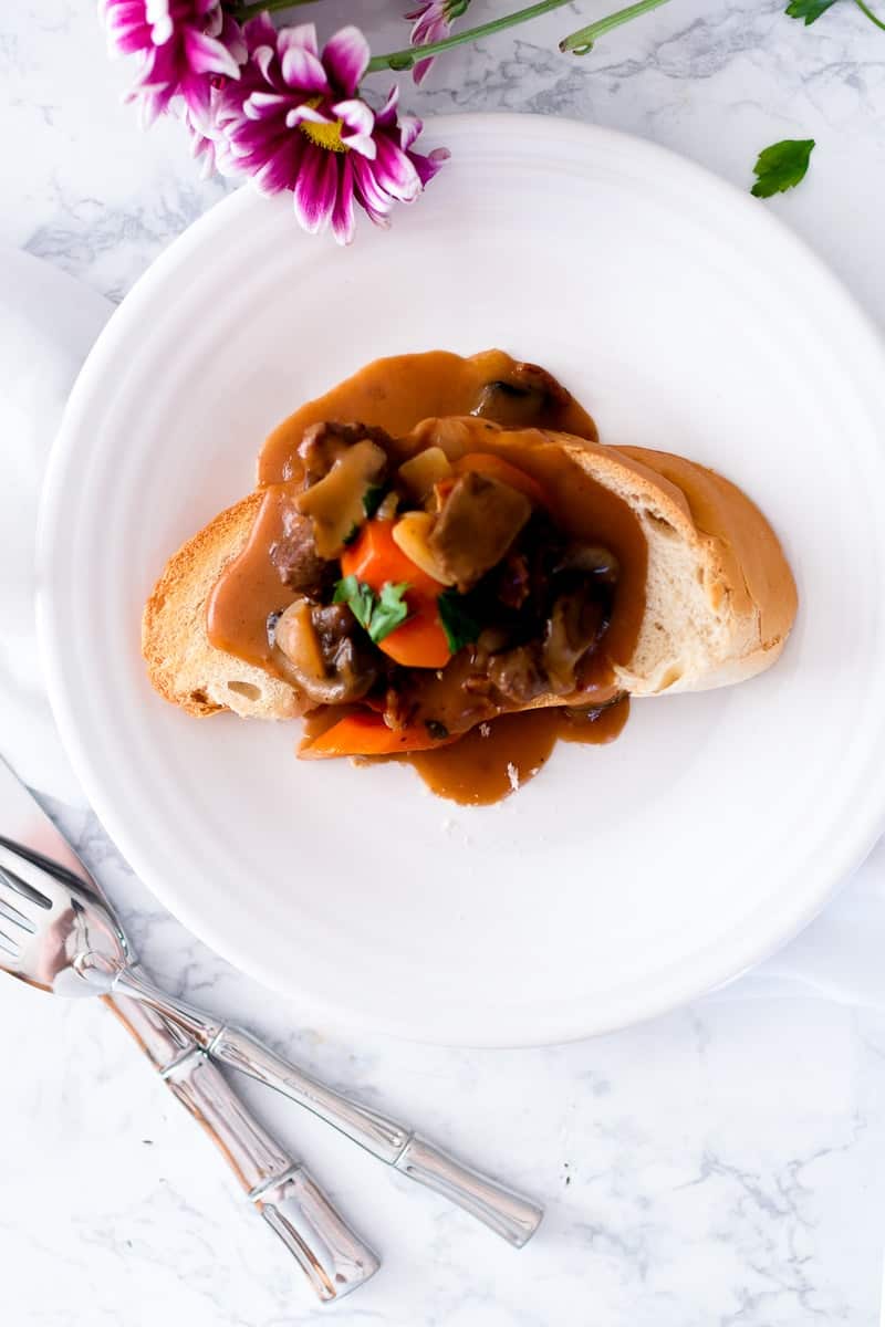 Slow Cooker Beef Bourguignon served on bread slice