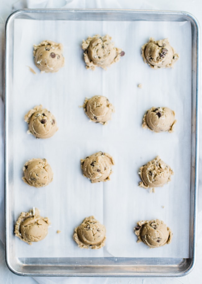 cookie dough on cookie sheet with parchment paper