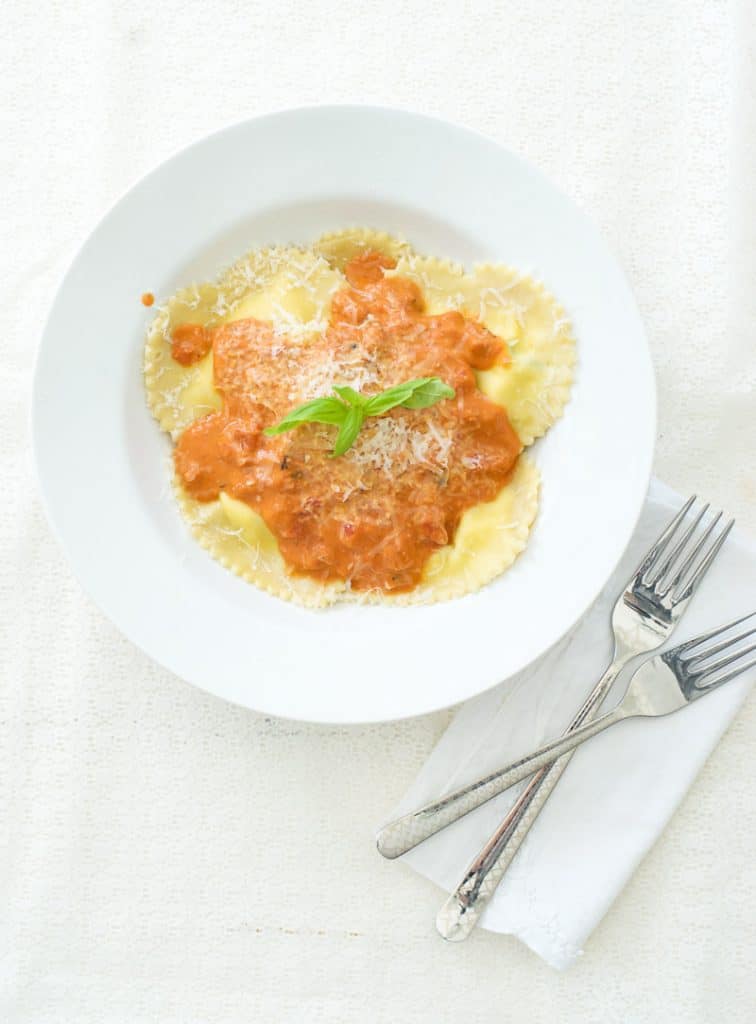 Ricotta and Basil Heart Ravioli in bowl with sauce