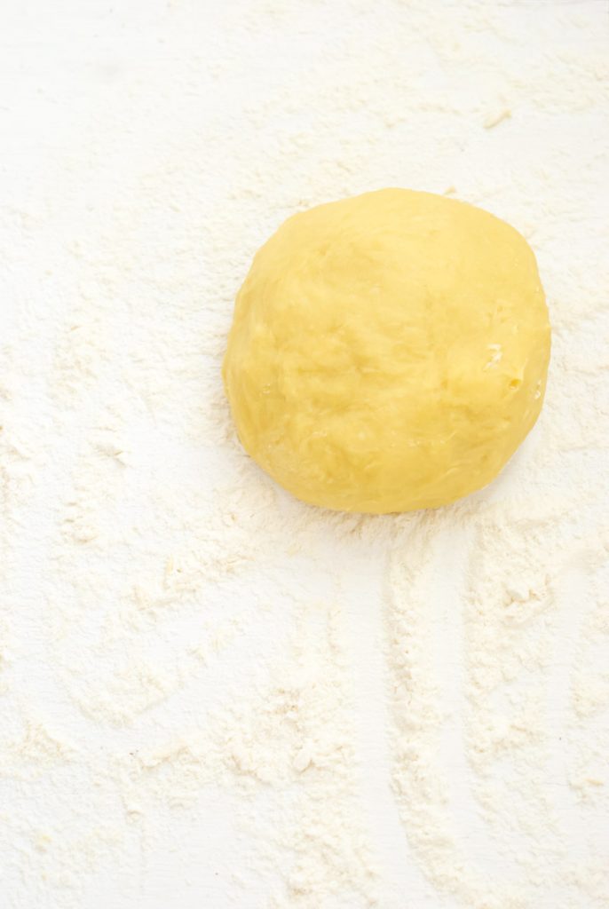 ravioli dough ball on heavily floured surface