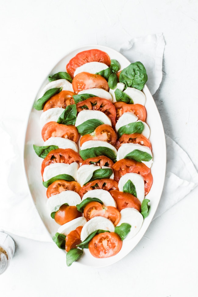 tomato, mozzarella and basil layered on a platter