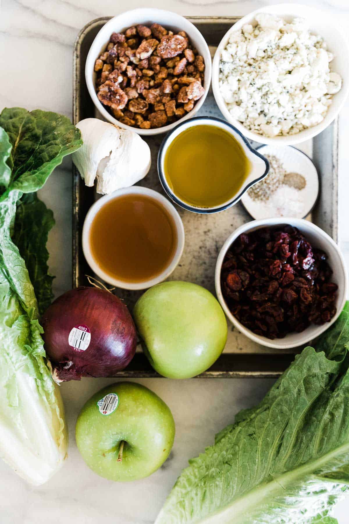 Ingredients to make apple gorgonzola salad on the table.