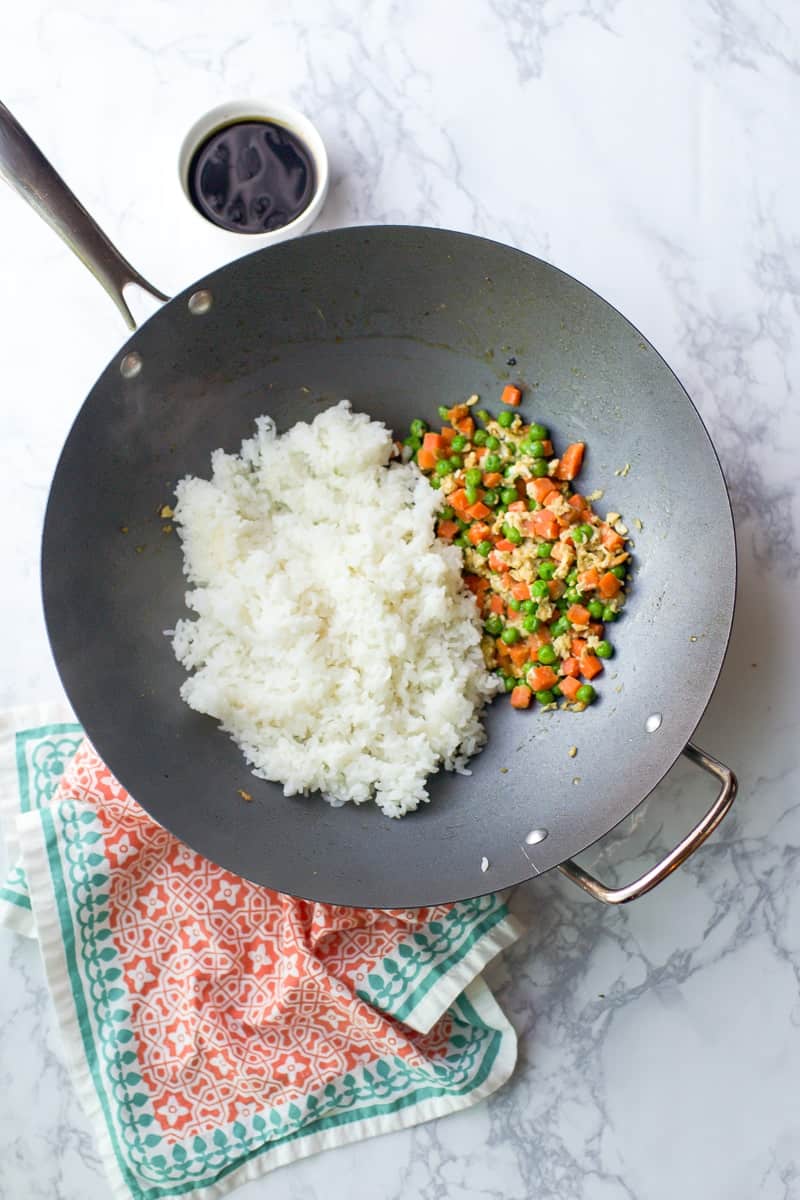 white plain rice with vegetables in skillet