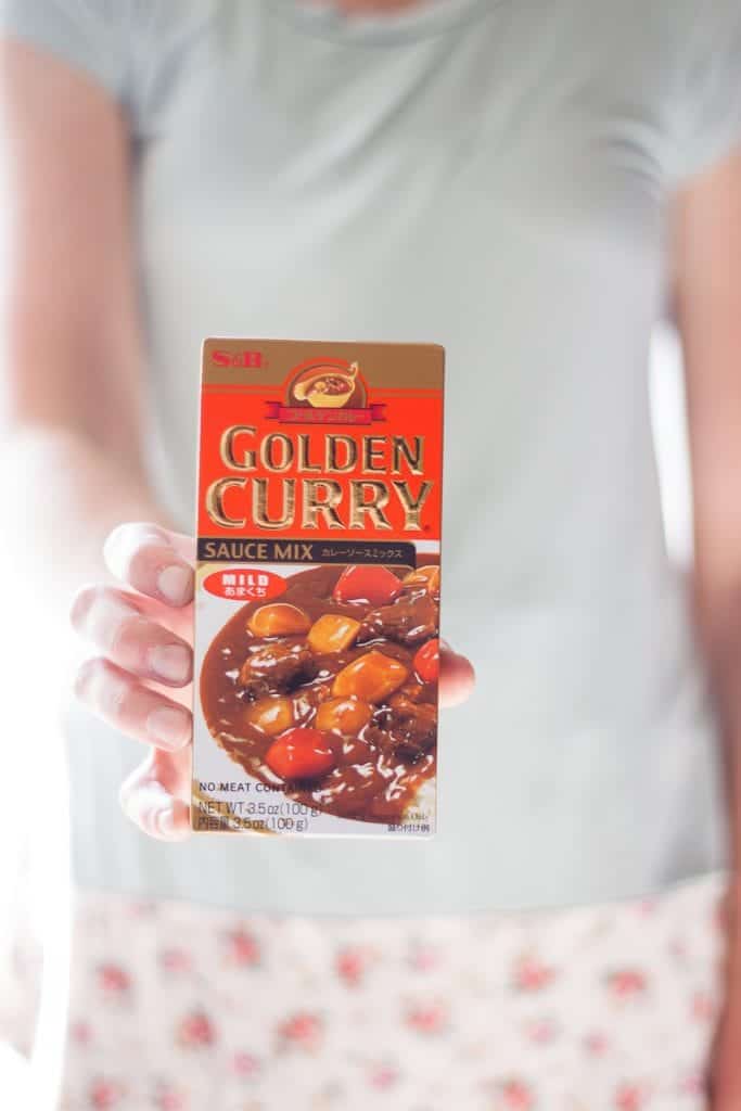 A photo of a woman holding a Japanese curry mix