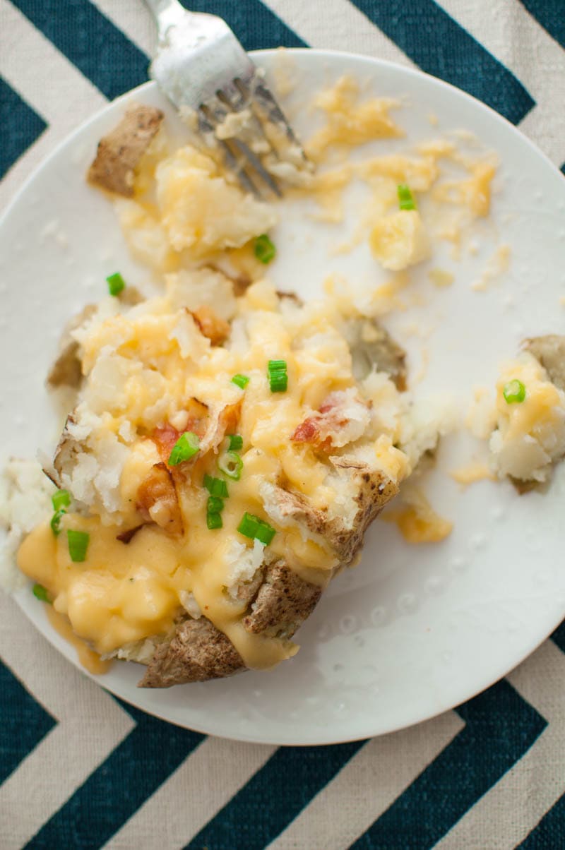 close up of baked potato with cheese sauce