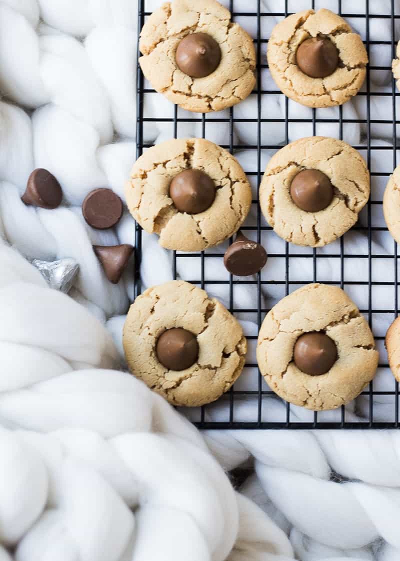 Peanut Butter Blossoms cookies on a black cooling rack