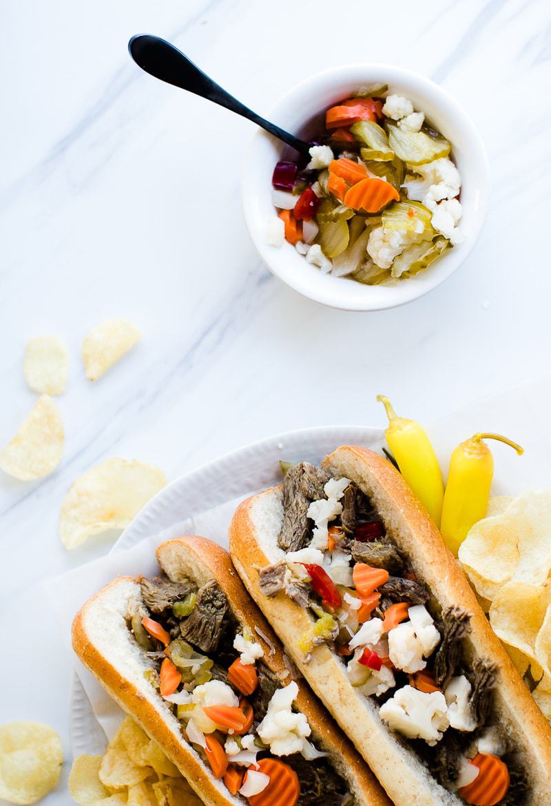 Instant Pot Italian Beef Sandwiches on plate with chips and peppers