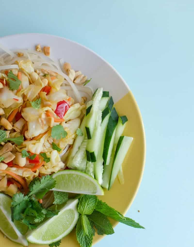 An overhead shot of a Thai cabbage stir fry on a yellow and white plate