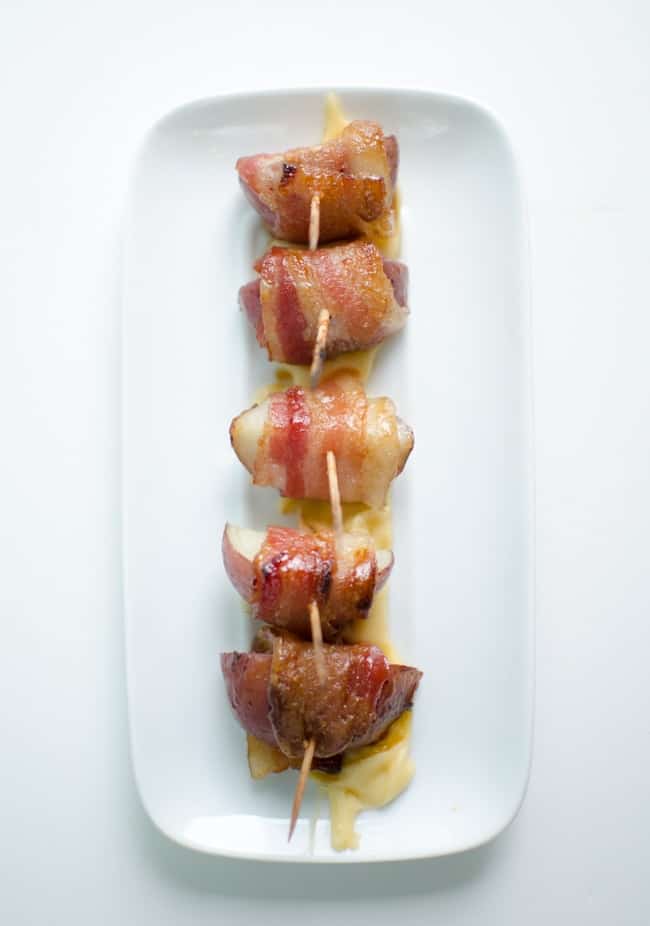 Bacon Wrapped Potatoes on a plate with cocktail sticks