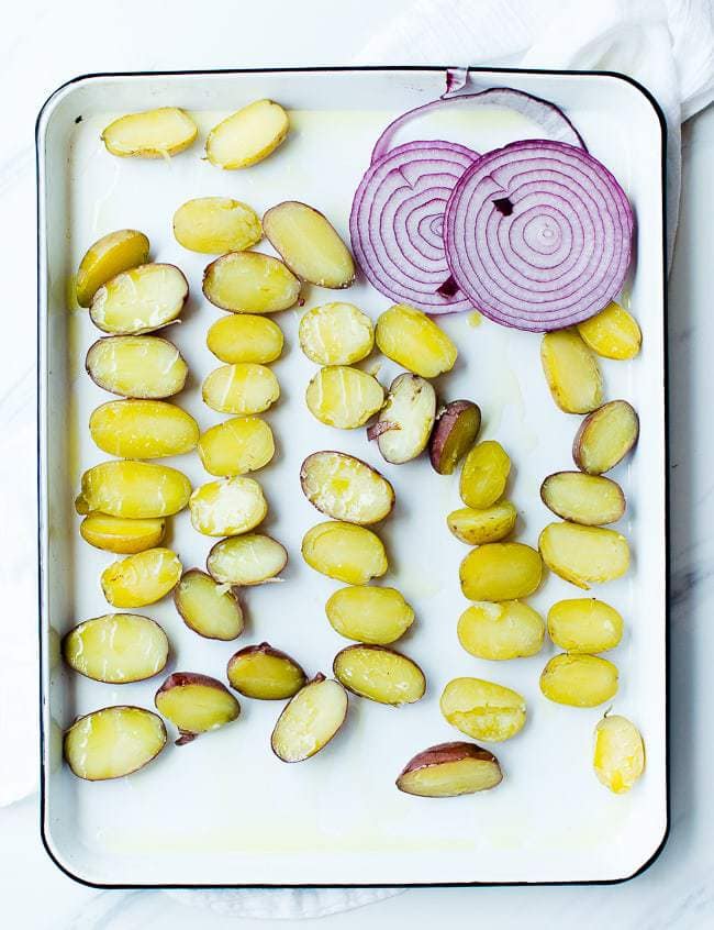 potatoes and onion on a baking sheet