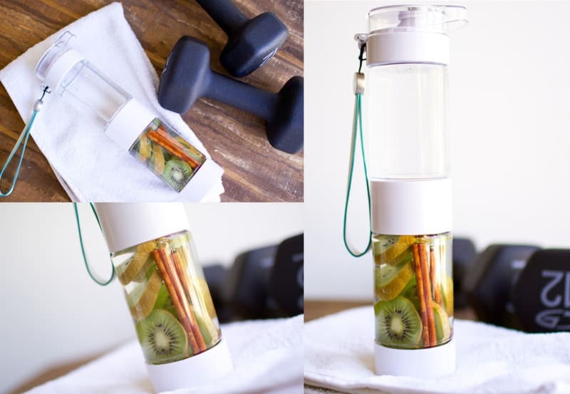 kiwi cinnamon infused water in infuser bottle, hand weights to the side