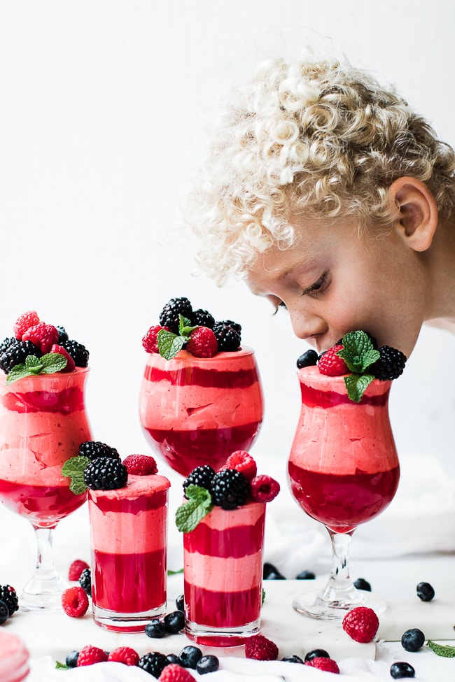child eating berries off jello