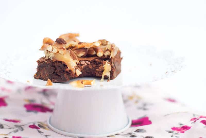 Caramel Pretzel Pecan Brownies with a bite out