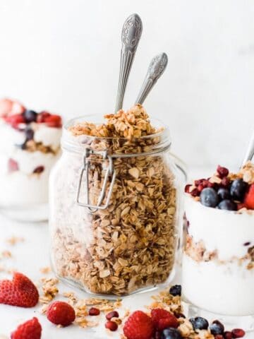 jar of granola with two spoons