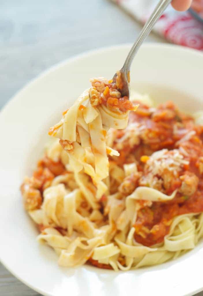 Hearty Pasta Sauce with Homemade Noodles being picked up by fork 
