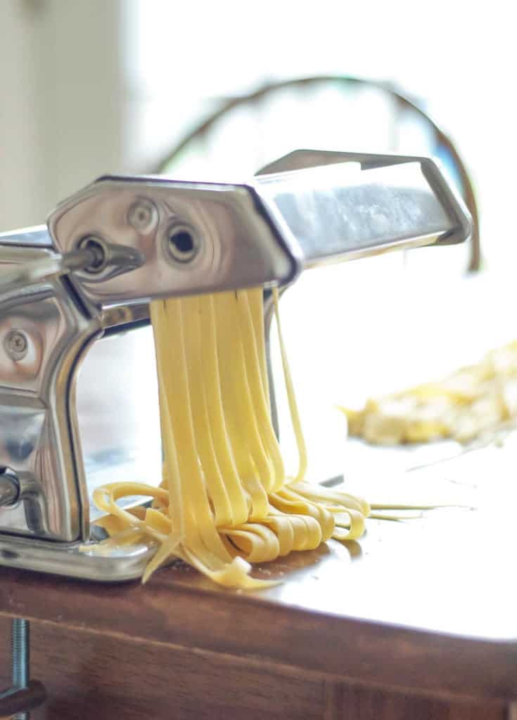 noodles going through pasta cutter