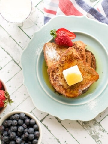 easy french toast on a plate with butter and fresh berries