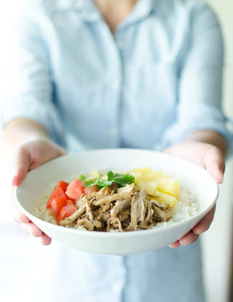 Kalua Pig Recipe in bowl with hands holding it 