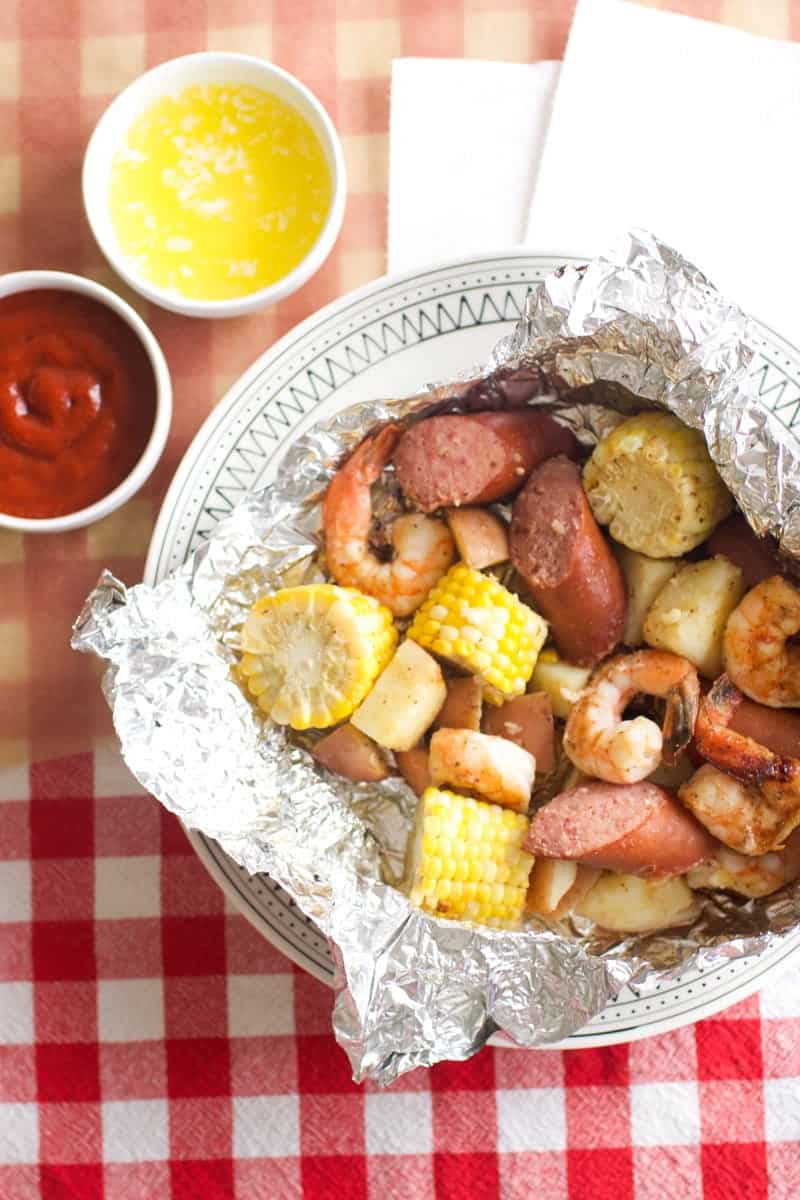 Shrimp Boil Foil Packs with ketchup and butter on the side