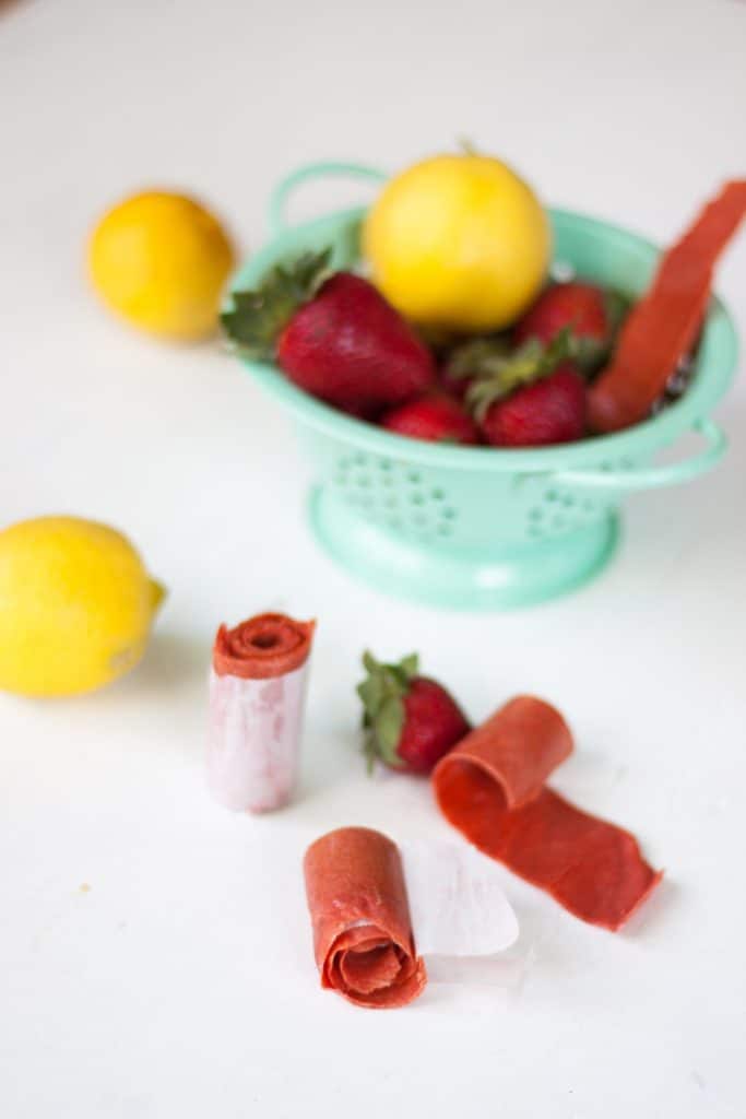 strawberry lemonade leather rolled up with fresh ingredients in drainer 