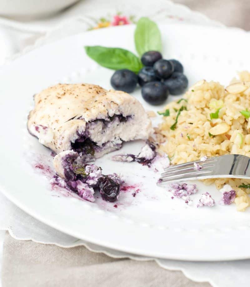 A close up of Blueberry Basil Chicken cut in half with Rice Pilaf