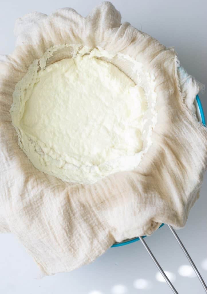An overhead shot of making homemade ricotta used for making a ricotta pizza