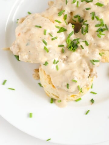An overhead shot of cheddar cheese biscuits and gravy