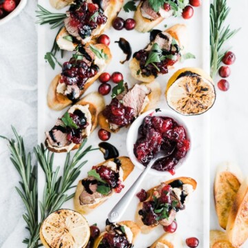 lamb, cranberry sauce on a baguette on a tray