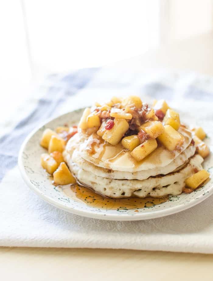 Sautéed Apples with Bacon on top on a stack of pancakes