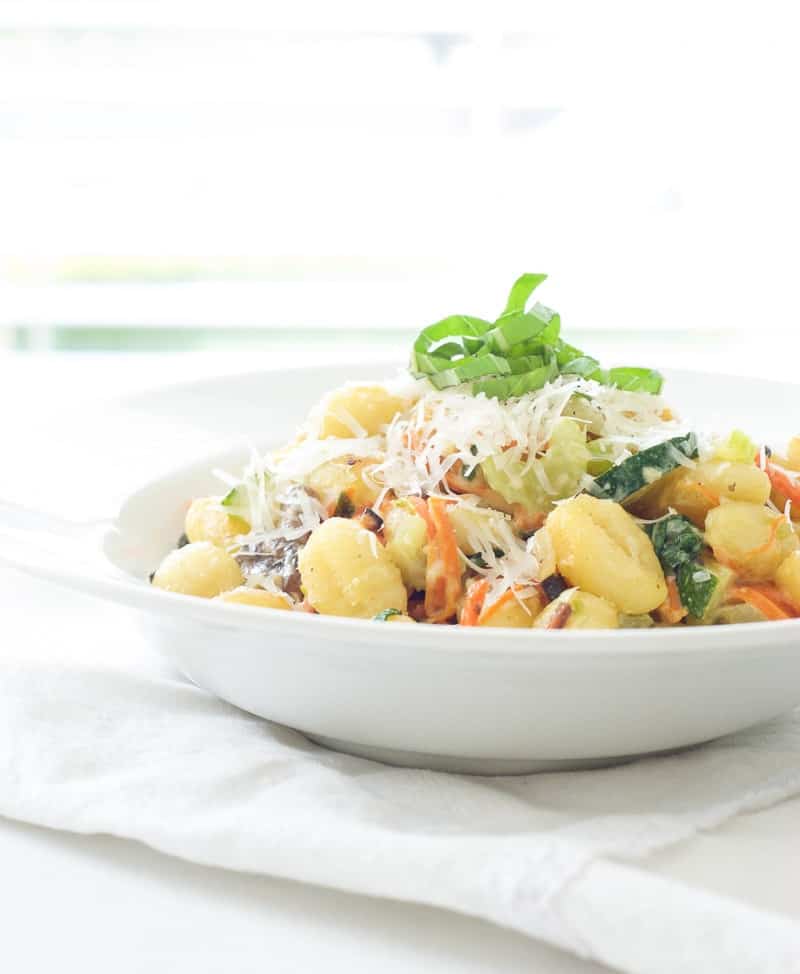Fried Gnocchi and Creamy Vegetable Bowls topped with green garnish