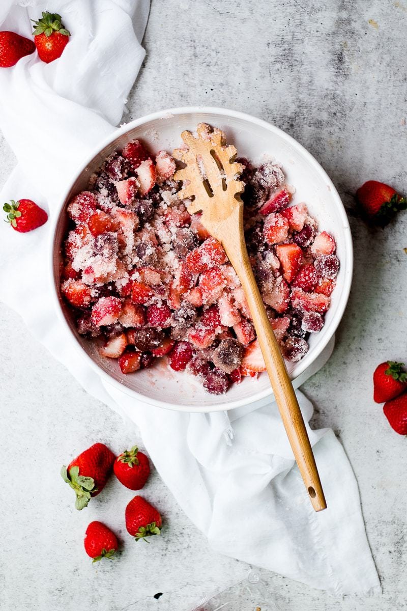 fresh berries with sugar in a white bowl