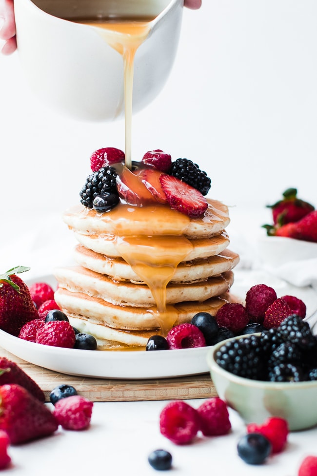 stack of pancakes with syrup pouring over