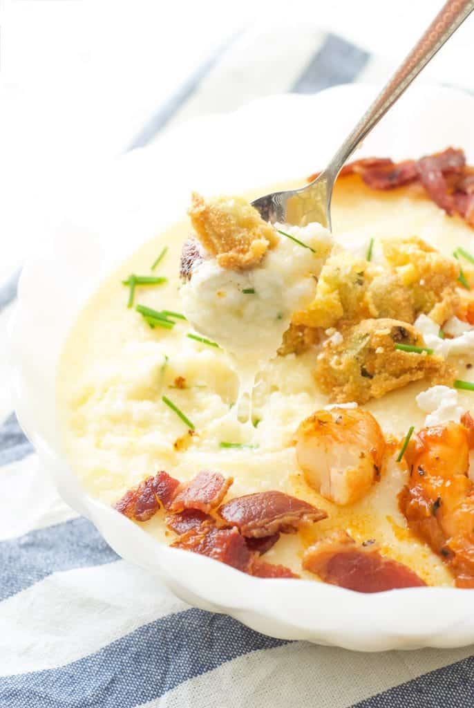 spoon going into Shrimp and Cheesy Grits with Fried Okra 