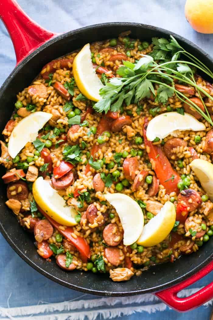 Chicken and Chorizo Paella garnished with parsley and lemon wedges
