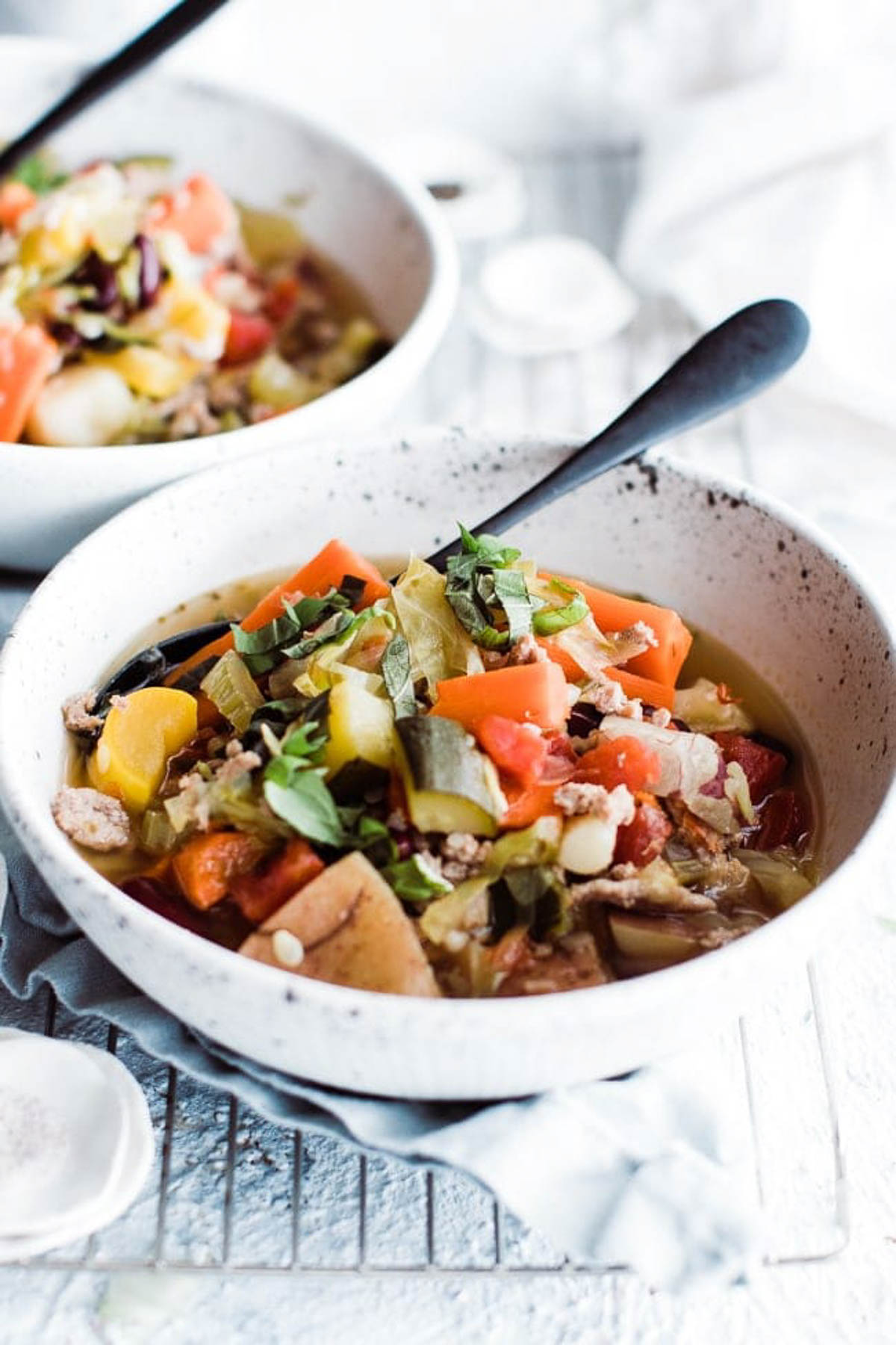 Vegetable weight loss soup in a bow with a spoon ready to eat.