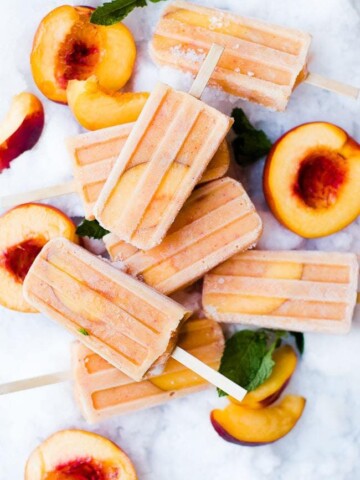 peaches and cream popsicles with fresh peaches on ice