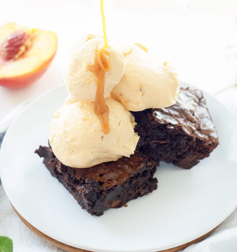 Peaches and Cream Frozen Custard on top of brownies and topped with caramel sauce