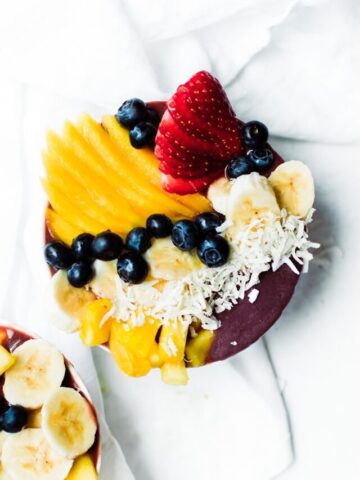 one bowl of acai with fresh fruit, berries and coconut